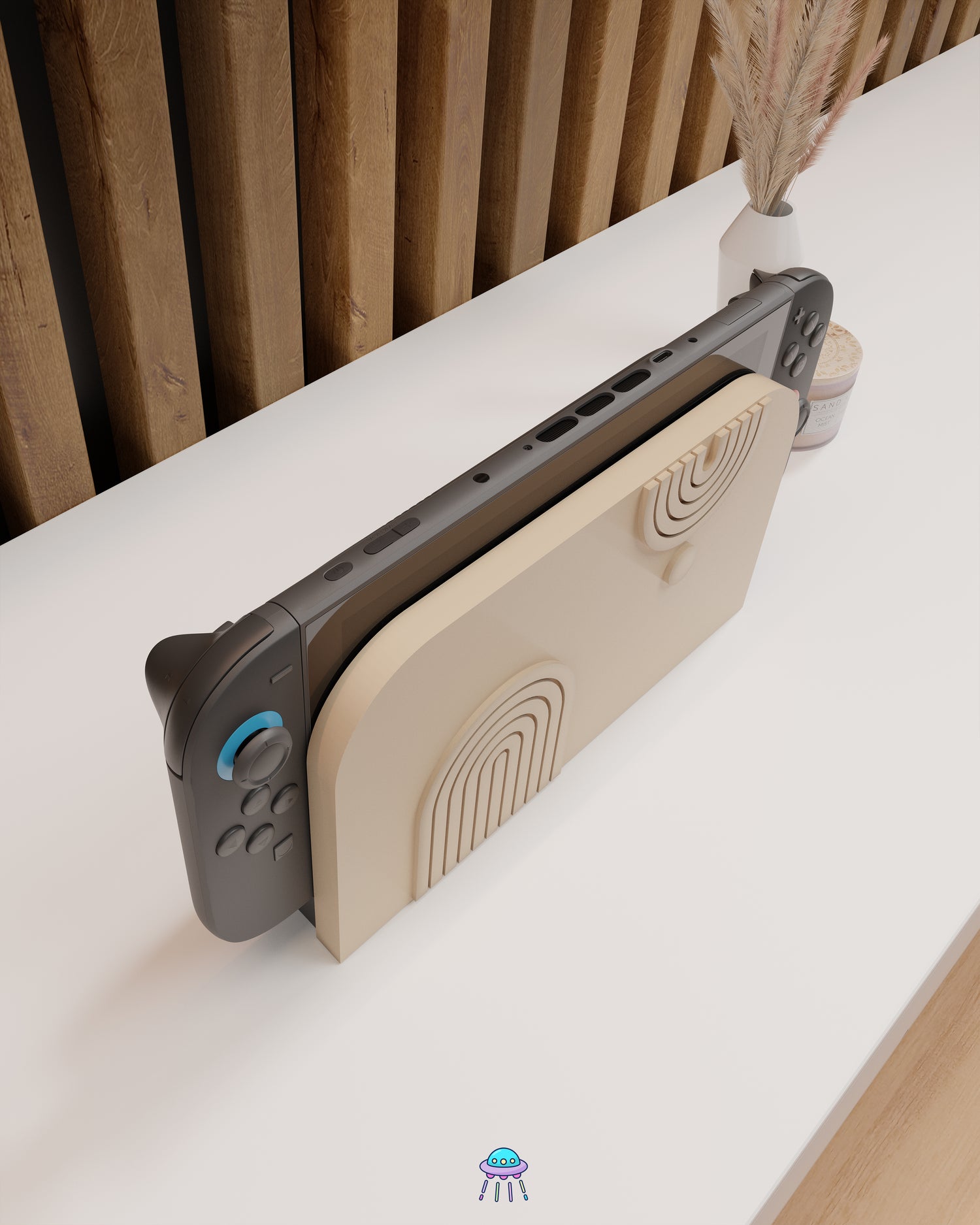 Top view of the Nintendo Switch 2 with Joy-Con controllers docked in a customised dock featuring a beige PLA filament cover and base. The cover has two embossed arch designs on the front—one larger arch at the bottom left and a smaller arch in the top right corner, alongside a small circular detail. The setup is placed on a white cabinet with a wooden panel background and decorative items nearby, including a candle and a vase with dried pampas grass.