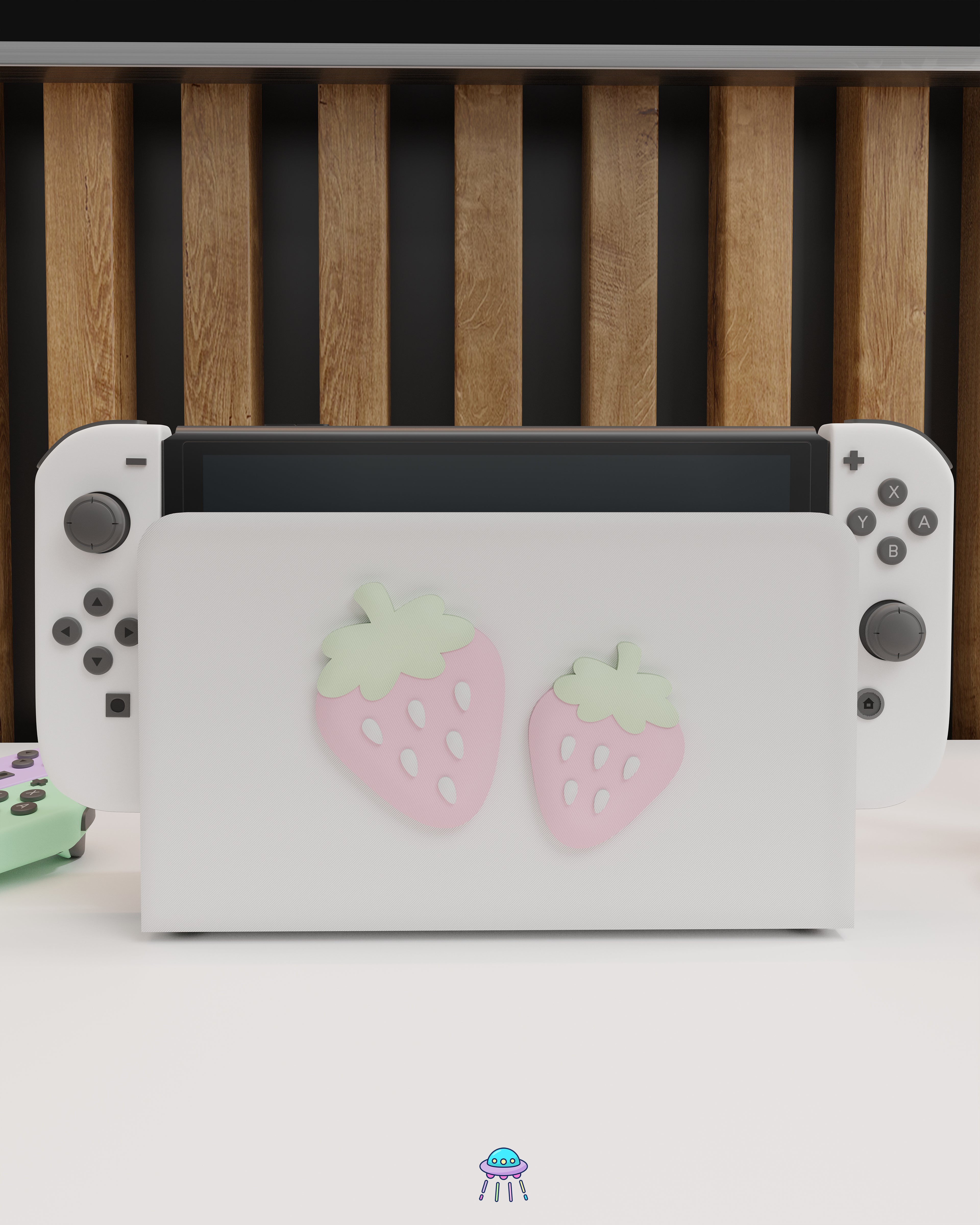 Front angle of a Nintendo Switch with Joy-Con controllers docked in a customised dock featuring a white PLA filament cover and pink base. The cover has two strawberry designs on the front—one larger to the left and a smaller strawberry to the right. The setup is placed on a white cabinet with a wooden panel background and decorative items nearby, including a candle and a vase with dried pampas grass.