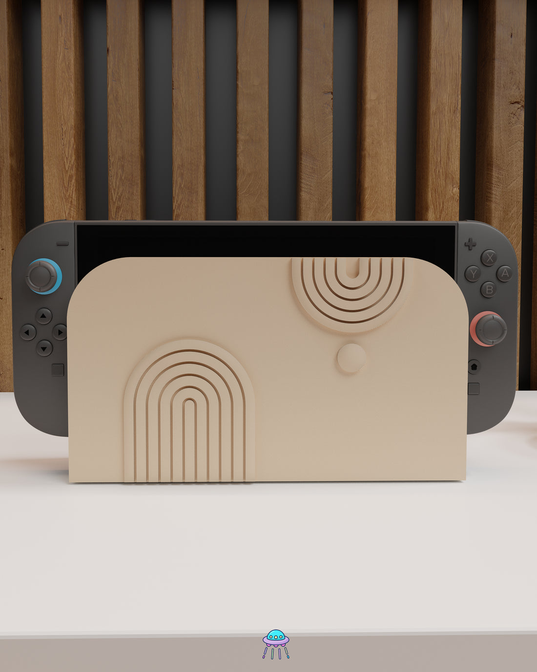 Front view of a Nintendo Switch 2 with Joy-Con controllers docked in a customised dock featuring a beige PLA filament cover. The cover has two embossed arch designs on the front—one larger arch at the bottom left and a smaller arch in the top right corner, alongside a small circular detail. The setup is placed on a white cabinet with a wooden panel background.